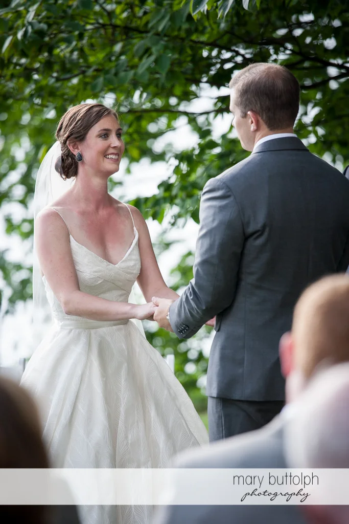 Couple hold hands and face each other in the garden at the Hamilton Inn Wedding