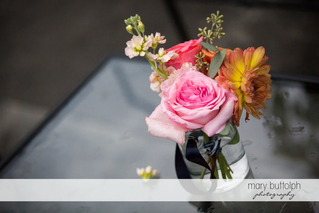 Flowers in a glass at the Inns of Aurora Wedding