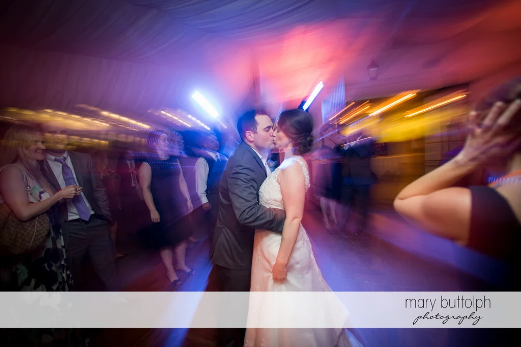 Couple kiss on the dance floor at the Inns of Aurora Wedding