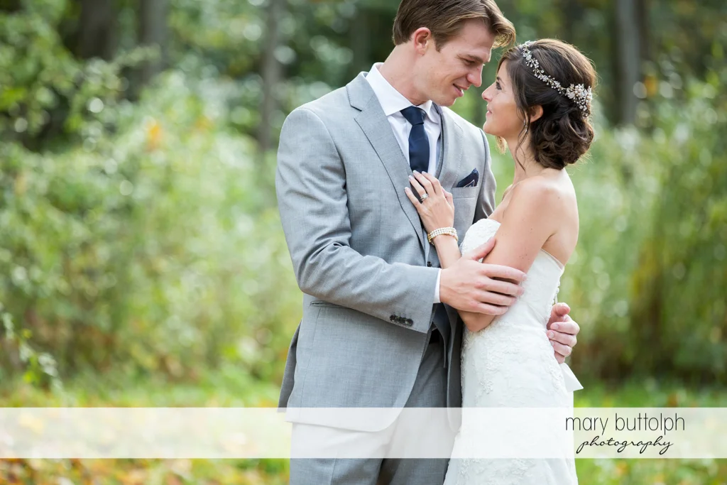 Couple share a happy moment in the garden at Anyela's Vineyards Wedding