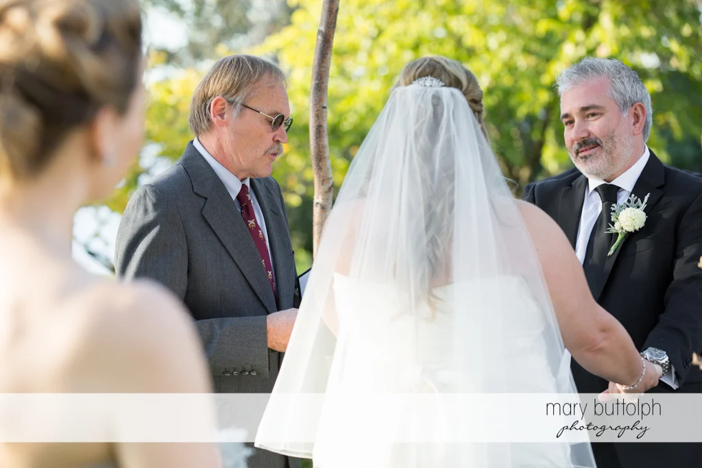 Couple in front of the wedding officiant at the Inns of Aurora Wedding