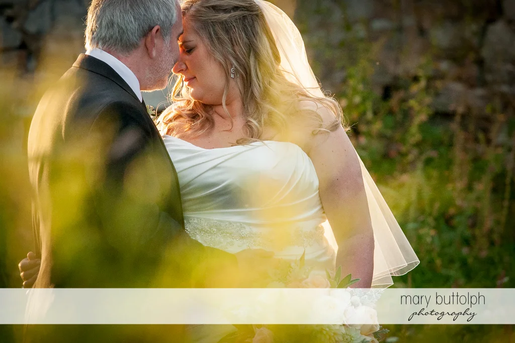 Couple rub noses in the garden at the Inns of Aurora Wedding