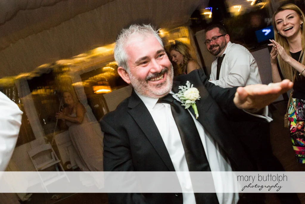 Groom shows his dance moves at the Inns of Aurora Wedding