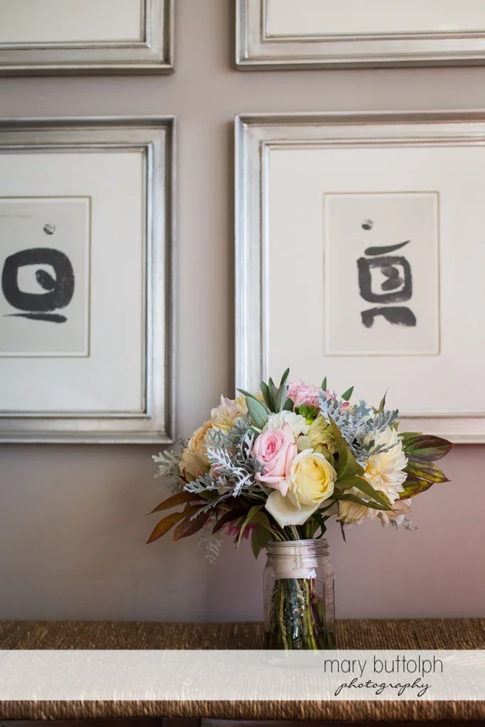 Bouquet in front of two paintings at the Inns of Aurora Wedding