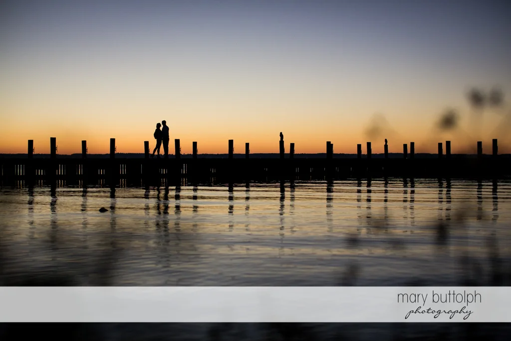 Couple stand by the lake at the Inns of Aurora Engagement