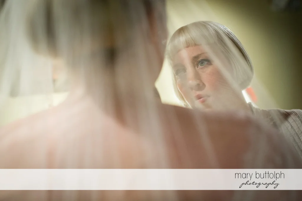 Bride faces one of the bridesmaids at Skaneateles Country Club Wedding