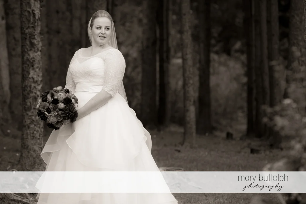 Dramatic black and white shot of the bride in the woods at Skaneateles Country Club