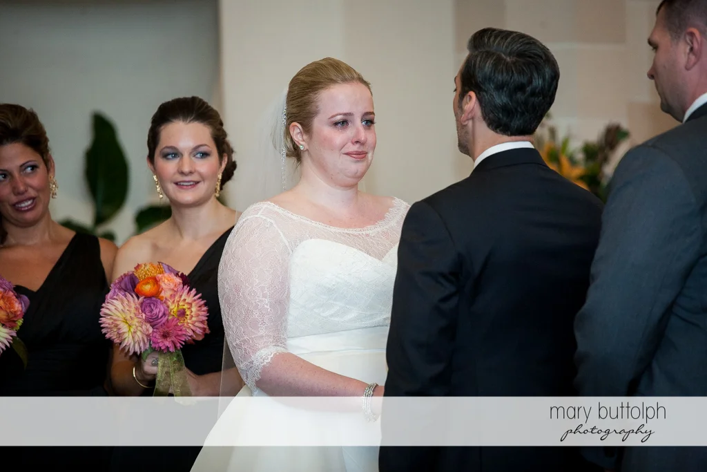 Couple face each other as the bridesmaids look on at Skaneateles Country Club Wedding