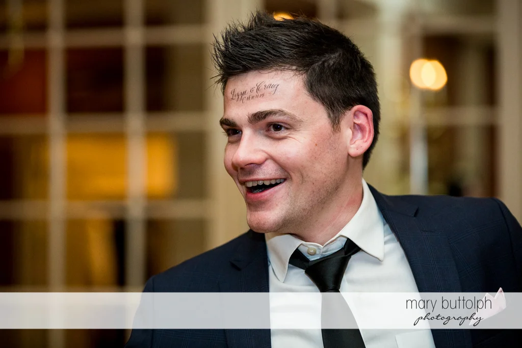 Guest with the couple's name on his forehead at Skaneateles Country Club Wedding