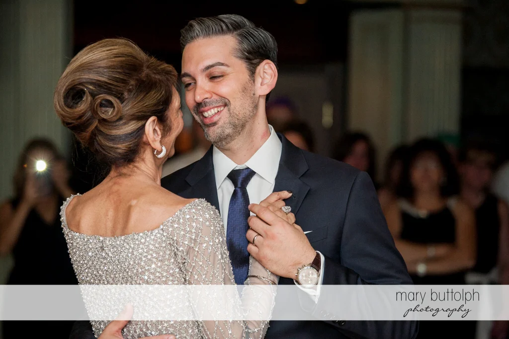 Groom dances with a guest at Skaneateles Country Club Wedding