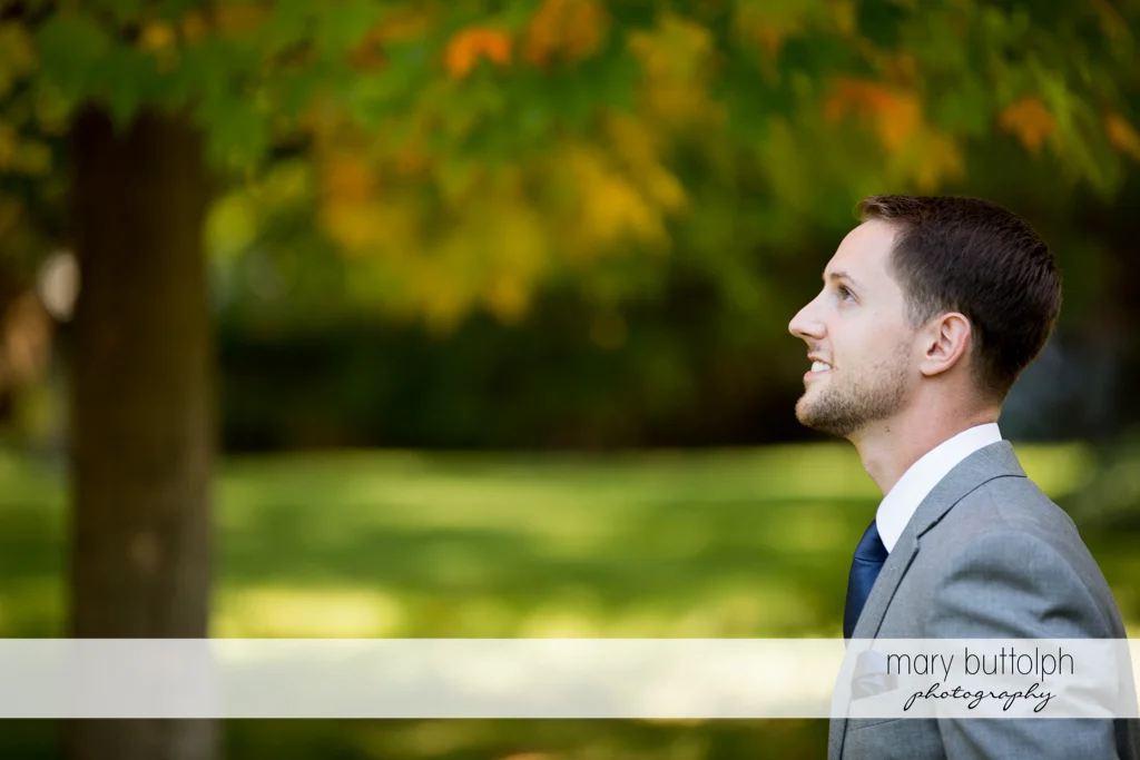 Groom waits for his bride in the garden at Skaneateles Country Club Wedding