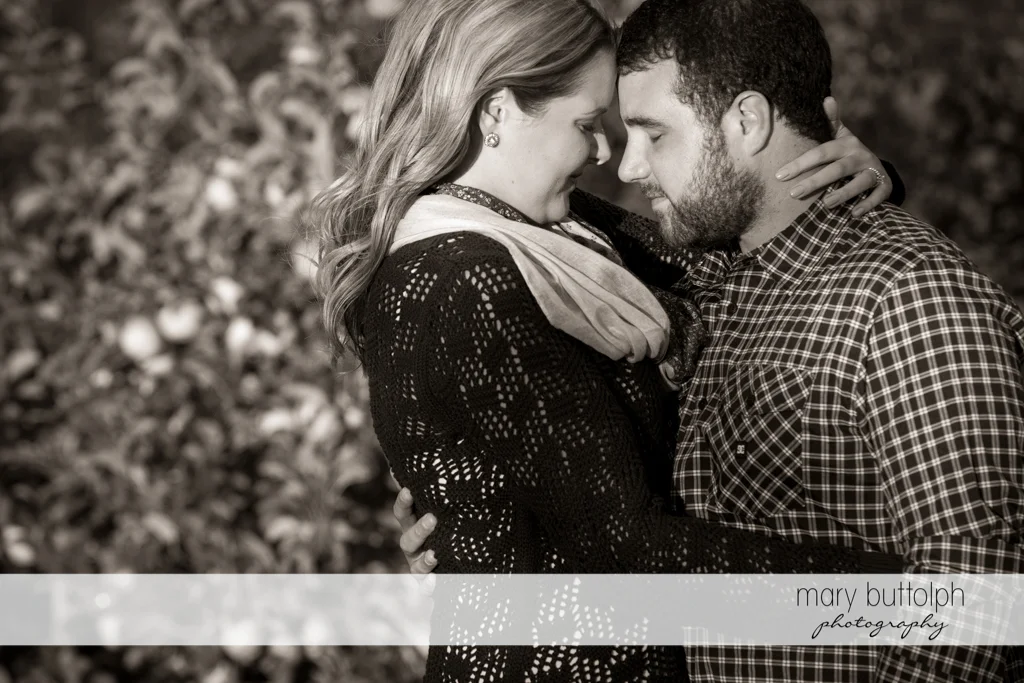 Couple in a dramatic black and white shot in the garden at Beak & Skiff Apple Orchards Engagement