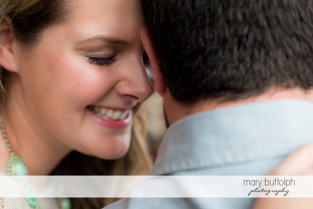 Close up shot of embracing couple at Beak & Skiff Apple Orchards Engagement