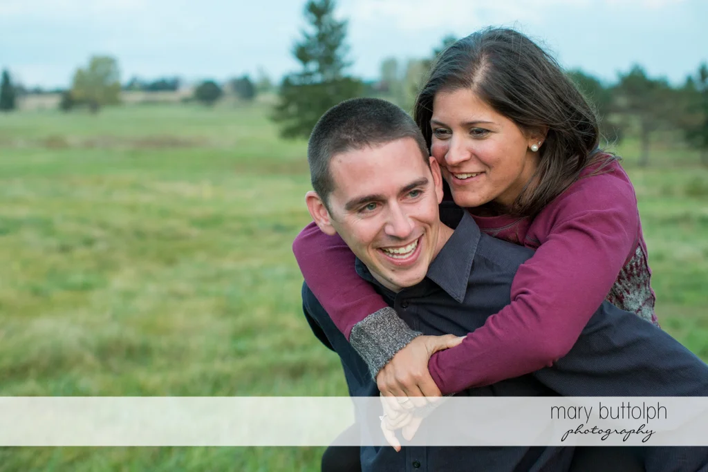 Couple horsing around in the garden at Skaneateles Lake Engagement