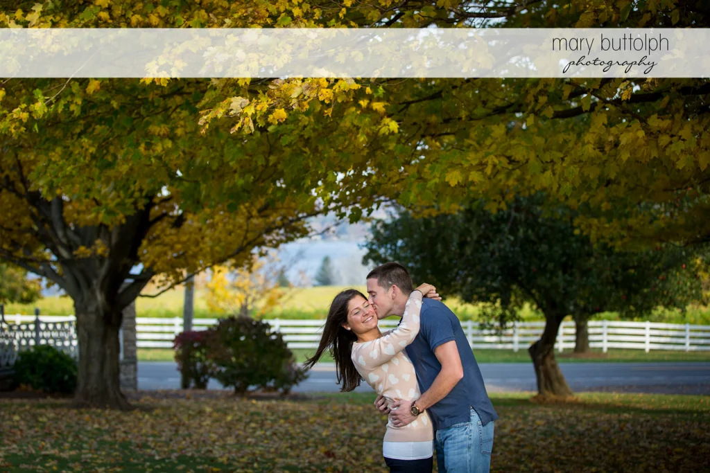 Couple express their love for each other in the garden at Skaneateles Lake Engagement