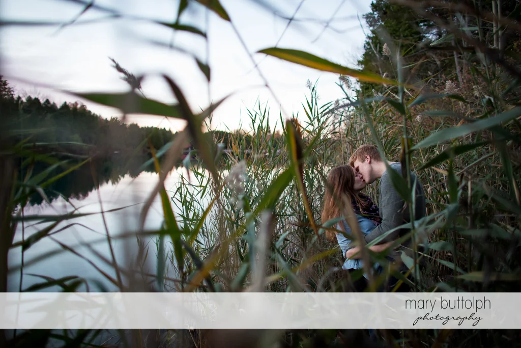 Couple show their affection by the lake at Green Lakes Engagement