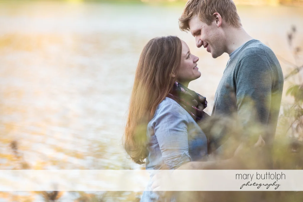 Couple pause by the lake at Green Lakes Engagement