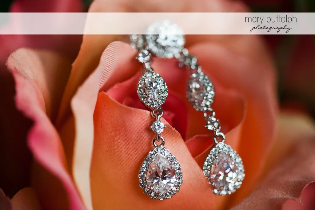 Bride's earrings on top of a flower at Rowland House Wedding