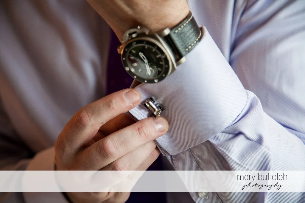 Close up shot of groom's watch and cufflink at Rowland House Wedding