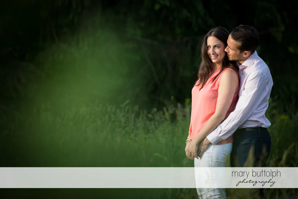 Couple cuddle up in the garden at Cazenovia Engagement