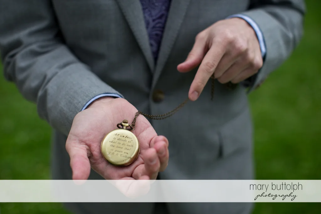 Man points to an old watch with a dedication on the back at Frog Pond Bed & Breakfast Wedding
