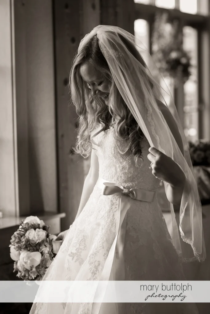 Bride admires her wedding dress at the Lodge at Welch Allyn Wedding