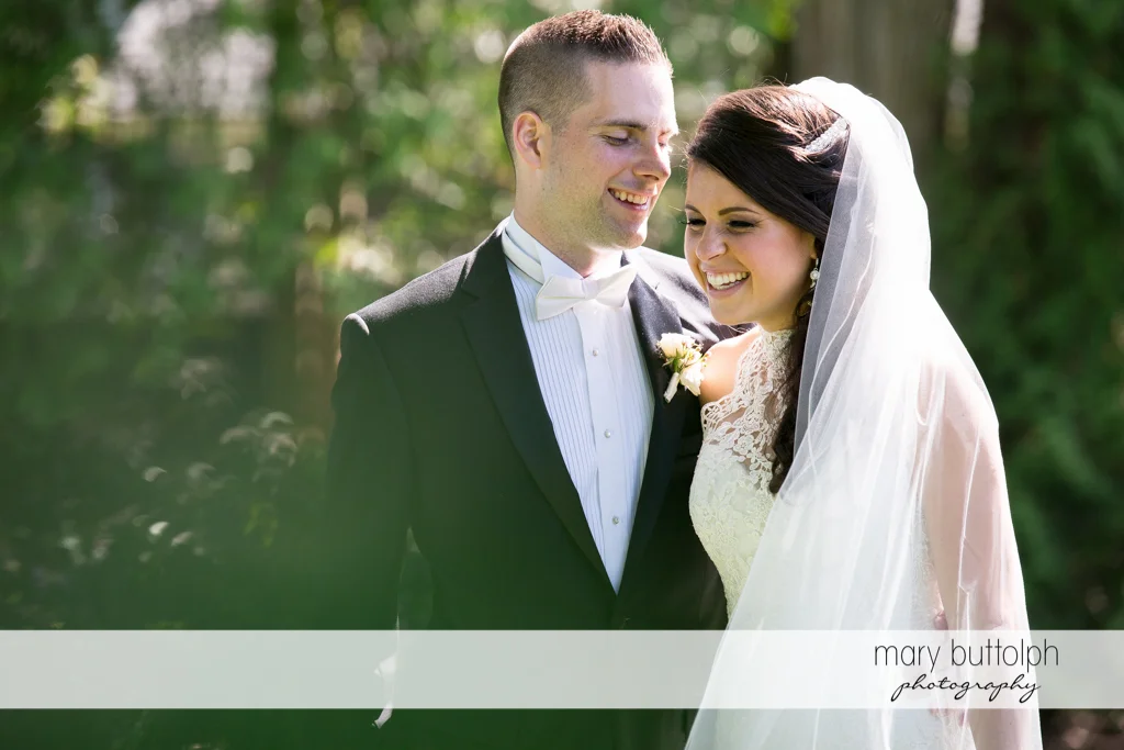 Couple share a tender moment in the garden at the Lodge at Welch Allyn Wedding