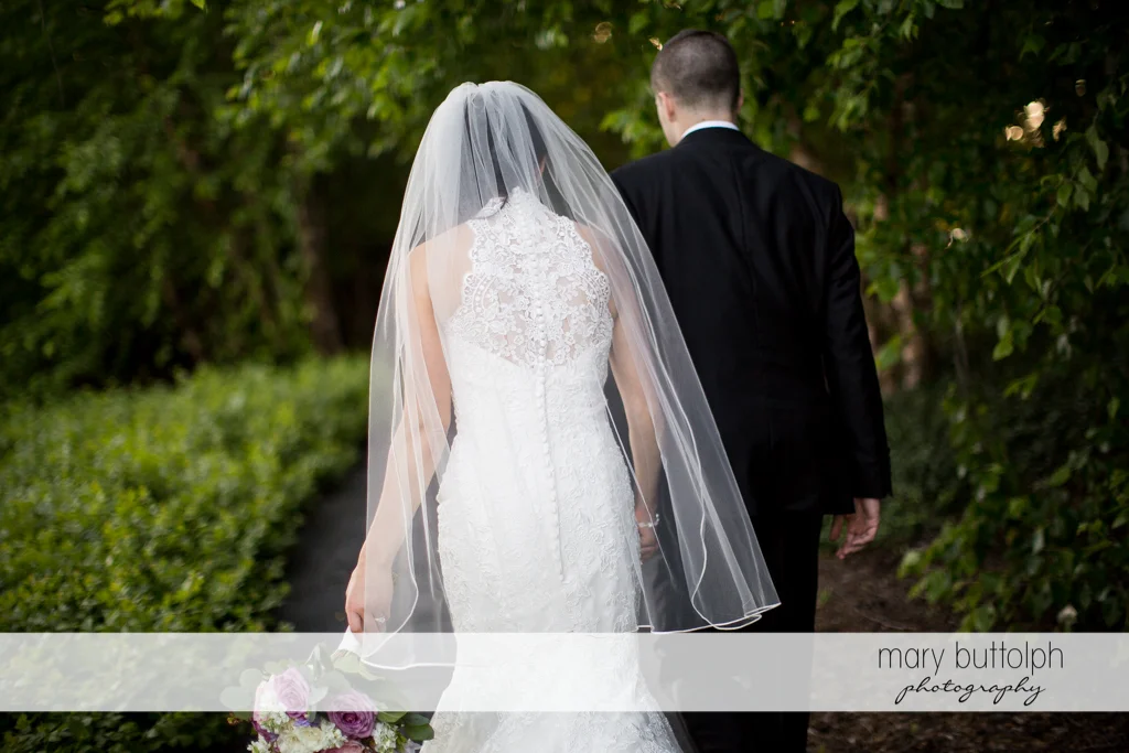 Couple walk together in the garden at the Lodge at Welch Allyn Wedding