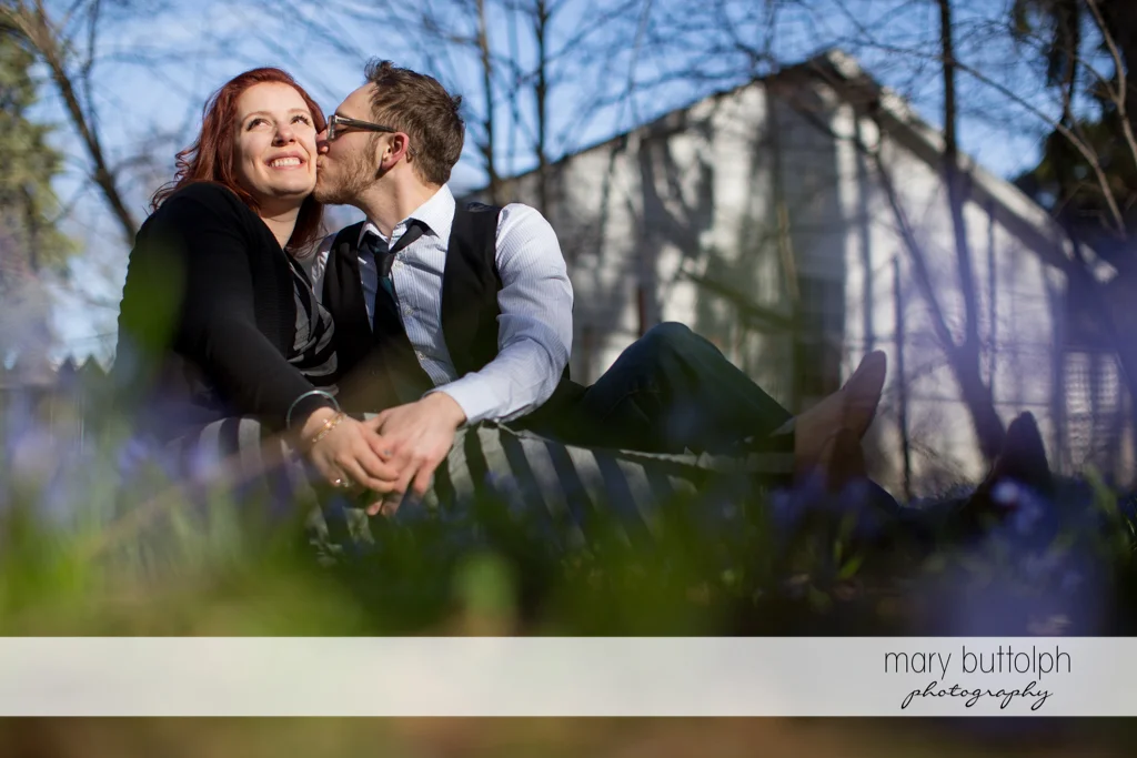 Couple share a tender moment at the park at Skaneateles Engagement