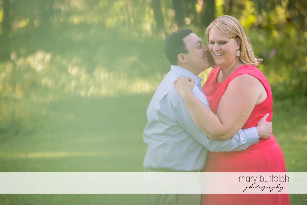 Couple embrace in the park at Skaneateles Lake Engagement