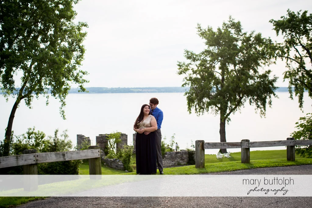 Couple cuddle up near the lake at Aurora Inn Engagement