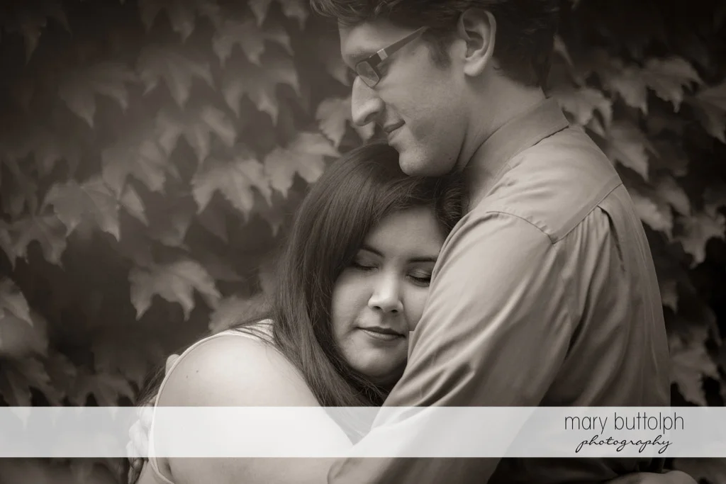Couple in a romantic mood in the garden at Aurora Inn Engagement