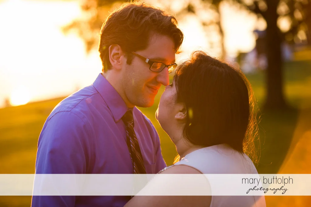 Couple in a tender moment as the sun sets at Aurora Inn Engagement