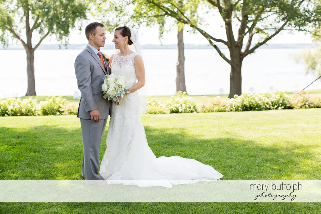 Couple pose in the garden by the lake at the Inns of Aurora Wedding