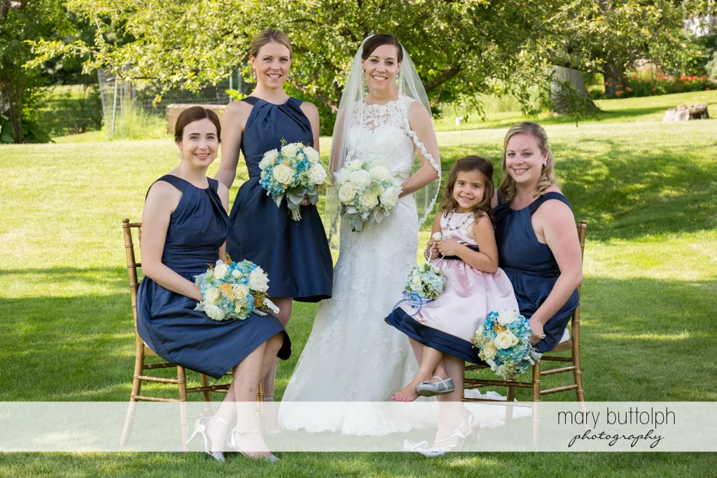 Bride and bridesmaids pose in the garden at the Inns of Aurora Wedding
