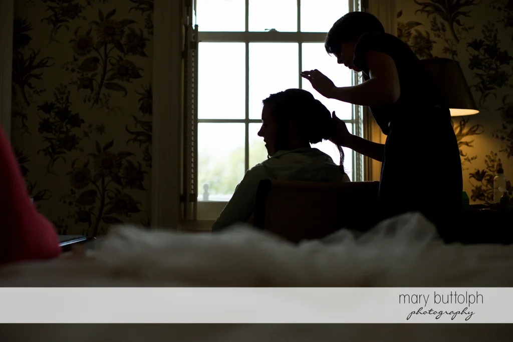 Bride gets a hair makeover from a friend at the Inns of Aurora Wedding