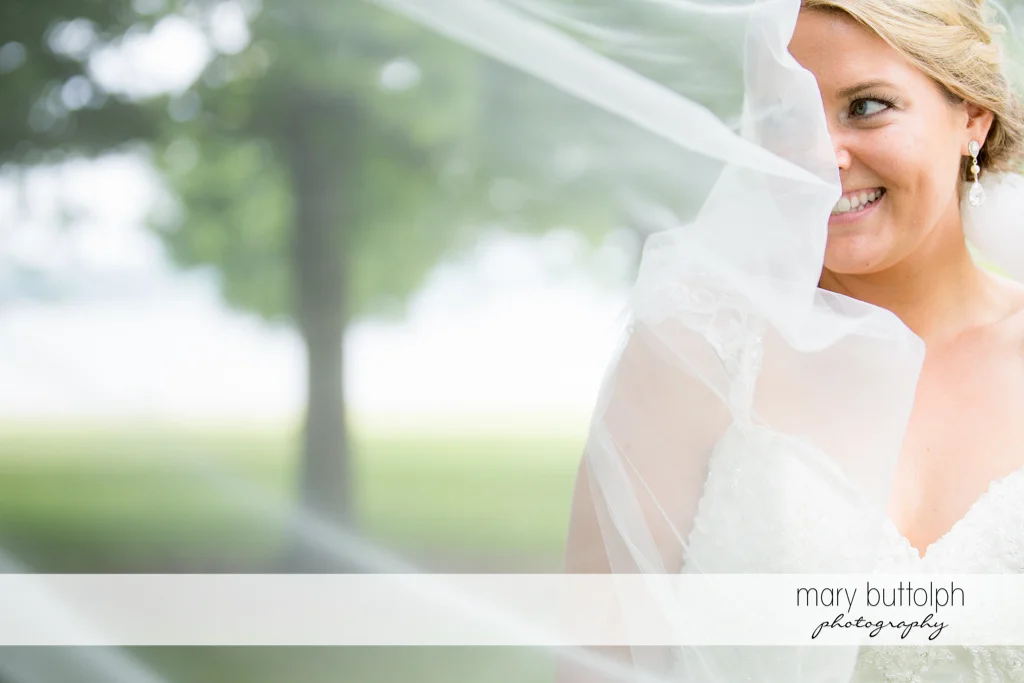 Bride appears to be having fun with her wedding veil at Emerson Park Pavilion Wedding