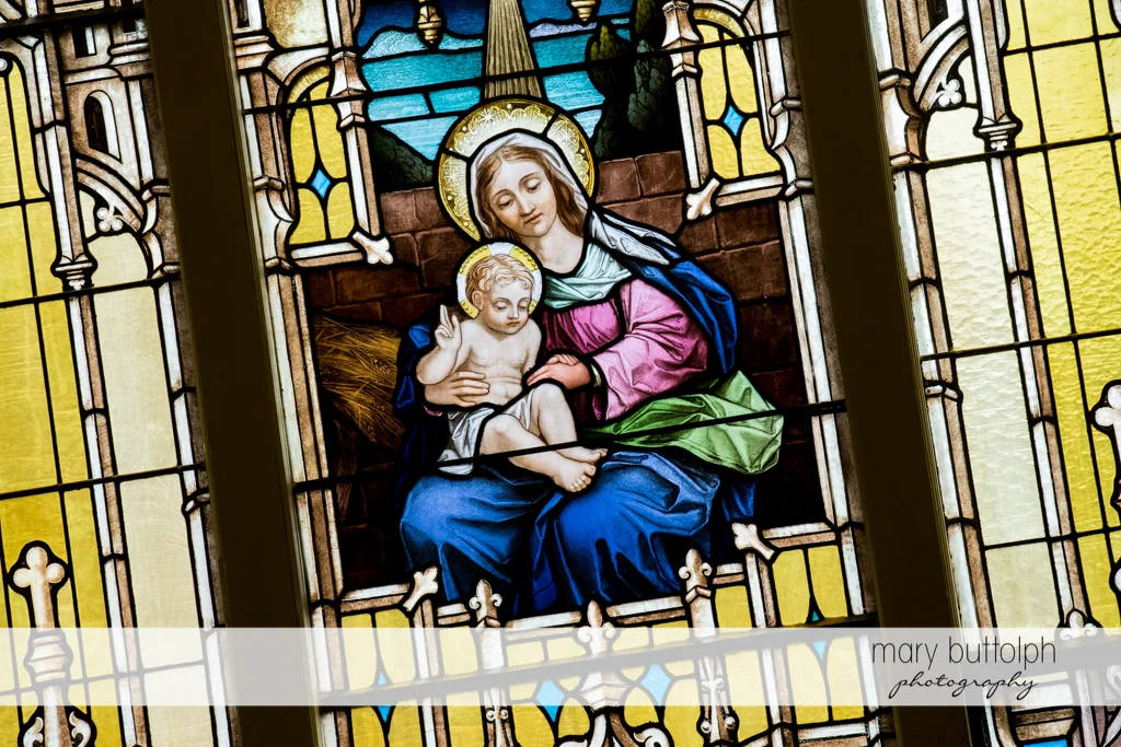 Stained glass window in church shows the Virgin Mary and Baby Jesus at Emerson Park Pavilion Wedding