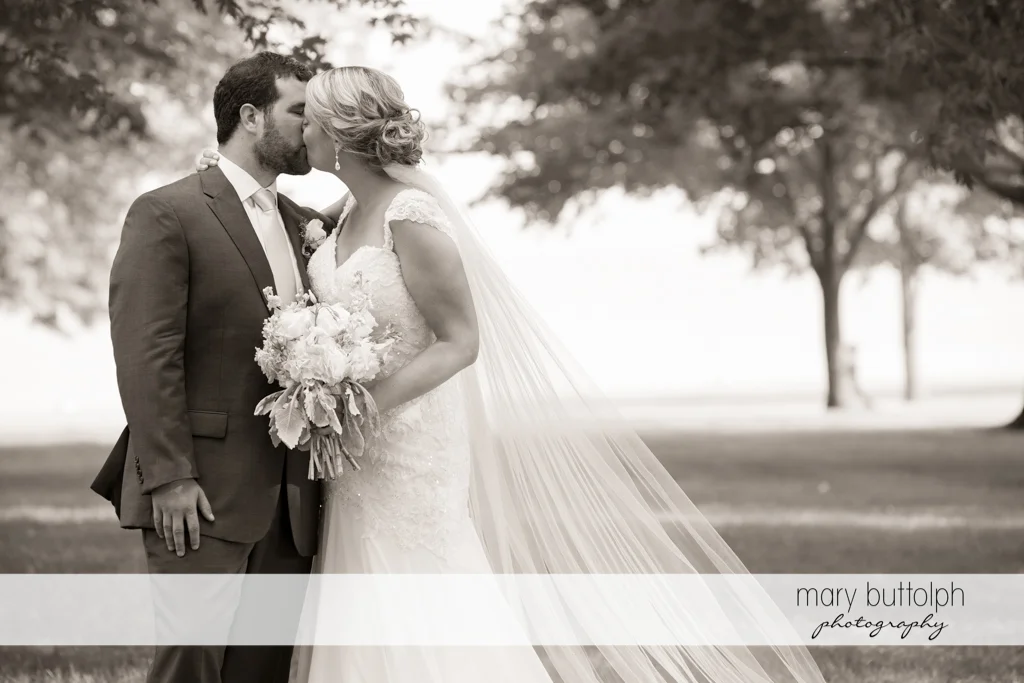 Couple kiss in the garden at Emerson Park Pavilion Wedding