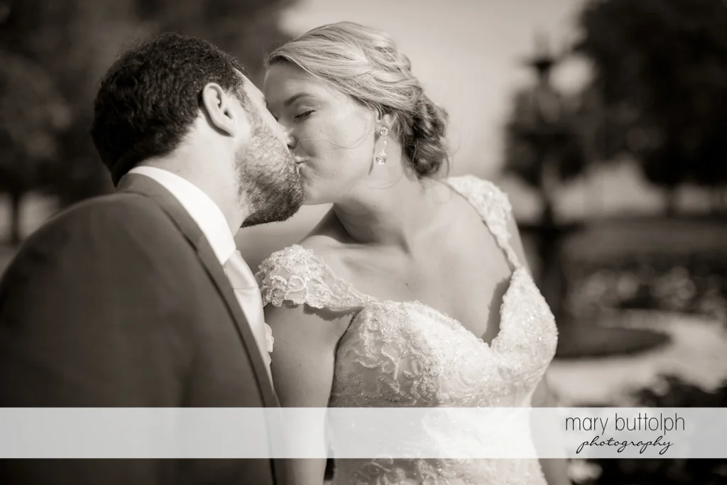 Couple kiss in the garden at Emerson Park Pavilion Wedding