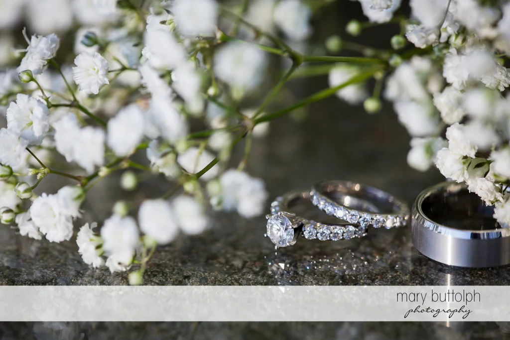 Couple's wedding rings with flowers at Emerson Park Pavilion Wedding
