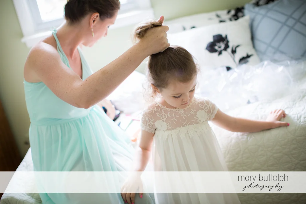 Young girl gets a hair makeover with the help of a friend at Emerson Park Pavilion Wedding