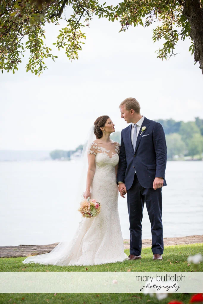 Couple stare at each other by the lake at Skaneateles Country Club Wedding