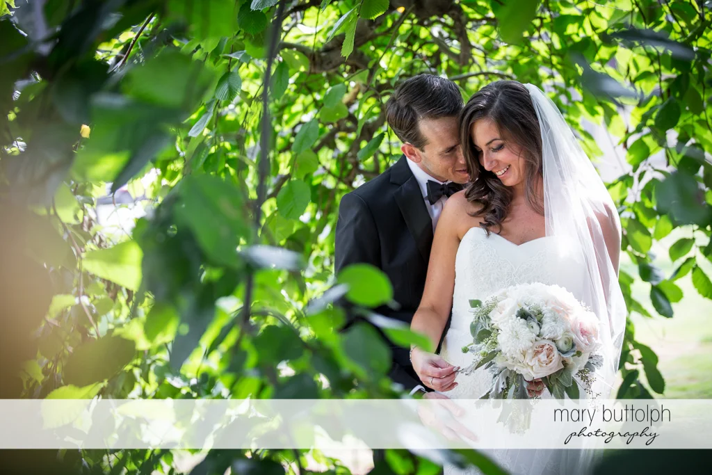 Couple share a romantic moment in the garden at the Brewster Inn Wedding