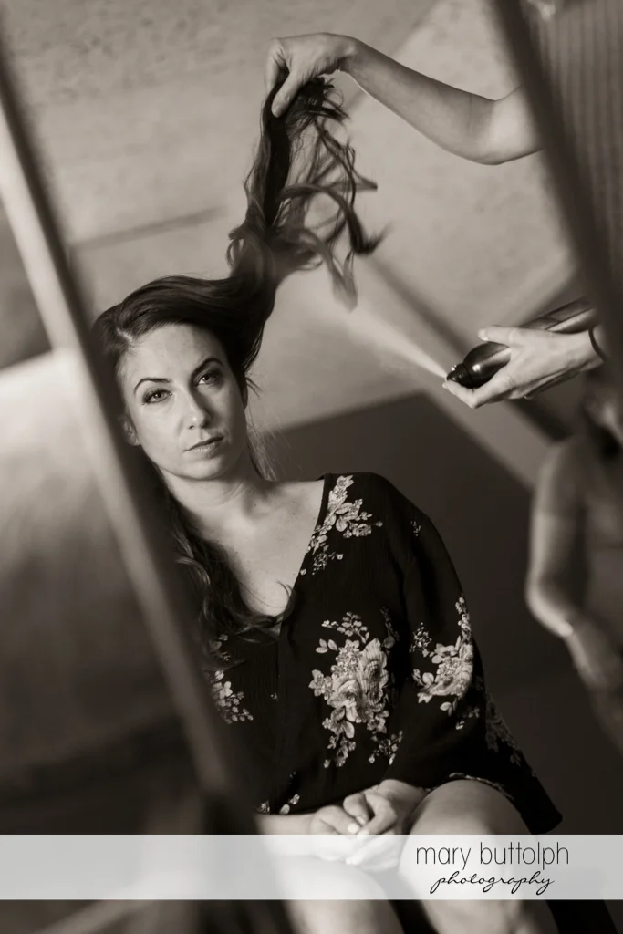 Bride's hair is sprayed to make it look good at the Brewster Inn Wedding