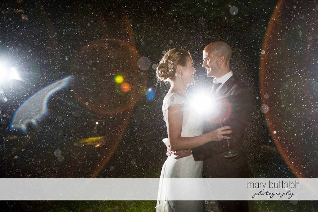 The rain can't stop this couple from smiling in the garden at the Inns of Aurora Wedding