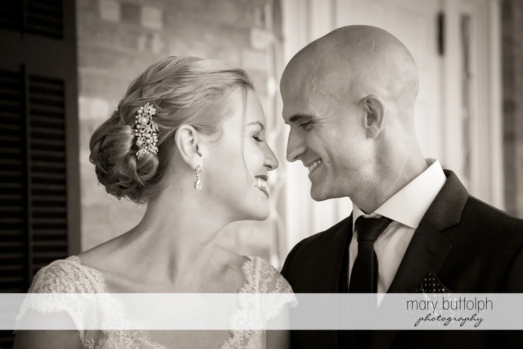 Couple share a happy moment on the porch at the Inns of Aurora Wedding