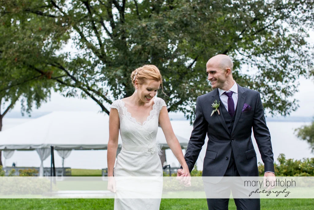 Couple hold hands in the garden at the Inns of Aurora Wedding