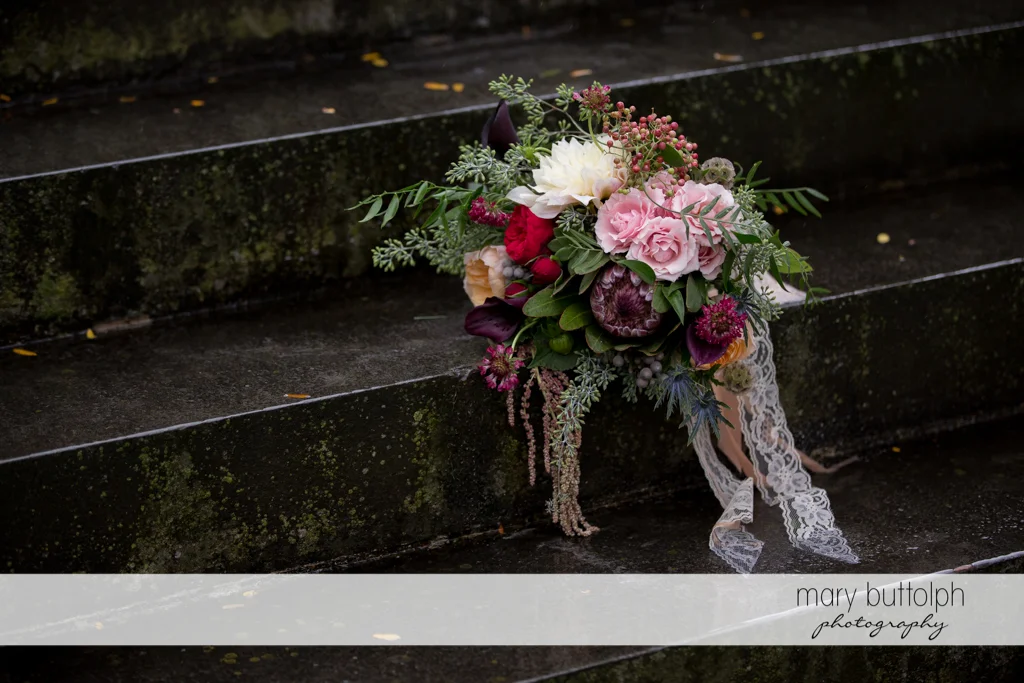 Colorful bouquet on the stone steps at the Inns of Aurora Wedding