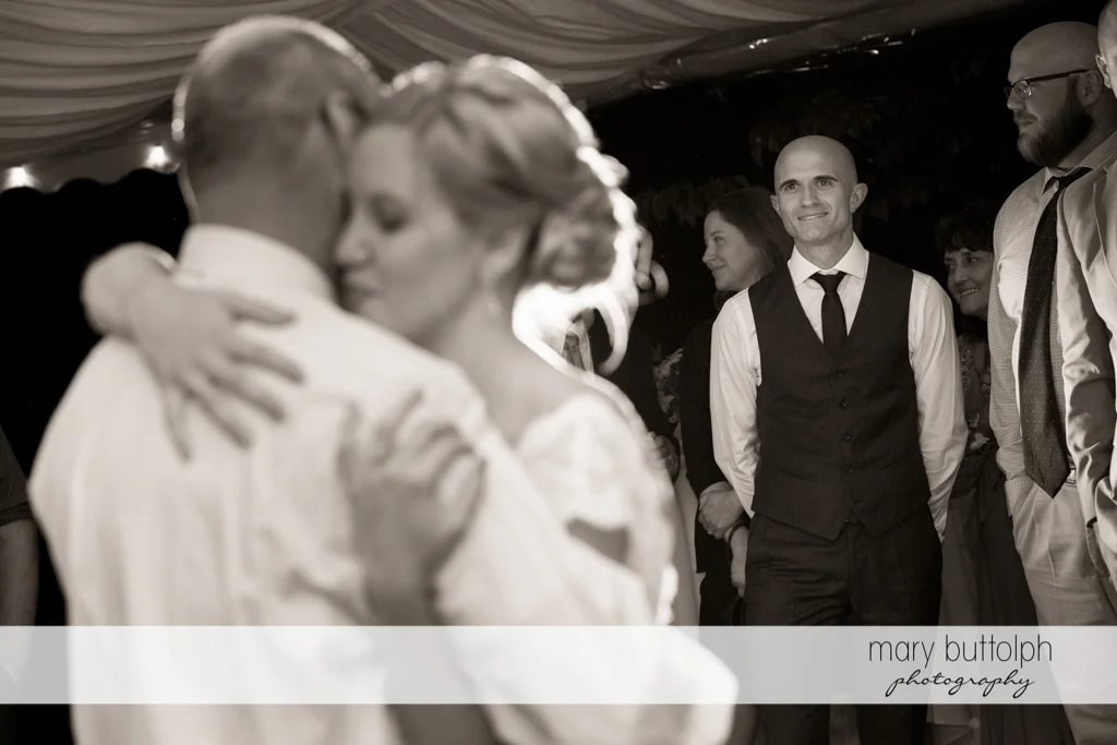 Groom looks at the bride dancing with her father at the Inns of Aurora Wedding